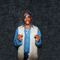 Rapper Tupac Shakur poses for photos backstage after his performance at the Regal Theater in Chicago, Illinois in March 1994.