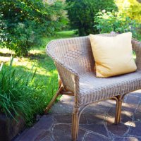 rattan bench with cushion in garden - garden decoration stock pictures, royalty-free photos & images