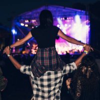rear view of a girl getting carried on a friends shoulders at the music festival. - concert stock pictures, royalty-free photos & images