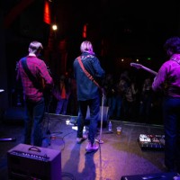 rear view of band performing for audience at small venue - concert stock pictures, royalty-free photos & images