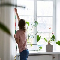 rear view of fashion designer measuring curtains on wall at home - home decoration stock pictures, royalty-free photos & images