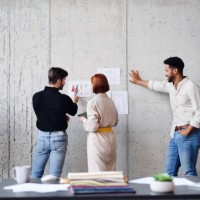 rear view of group of entrepreneurs designers, brainstorming. - fashion stock pictures, royalty-free photos & images