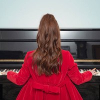 rear view of woman playing piano - concert stock pictures, royalty-free photos & images