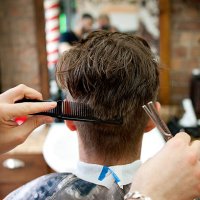rear view of young man in barbershop having haircut - hairstyle stock pictures, royalty-free photos & images