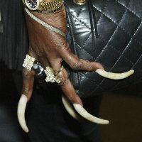 Recording artist Claudia White displays her fingernails during the opening of Donna Summer's Art Rock exhibit at the Entertainment Gallery in the...