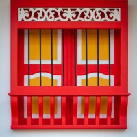 red and yellow window forming a cross in a white background, characteristic of the town of jerico, antioquia, colombia - garden decoration stock pictures, royalty-free photos & images