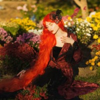 redhead woman in red gothic dress in garden. halloween style. long hair. autumn - garden decoration stock pictures, royalty-free photos & images