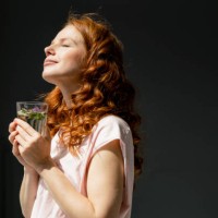 redheaded woman enjoying sunlight - food stock pictures, royalty-free photos & images