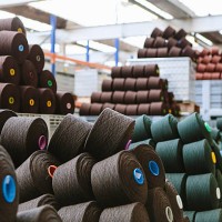 reels of wool in storage room in woollen mill - fashion stock pictures, royalty-free photos & images
