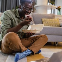 relaxed afternoon at home and consuming internet content - junk food stock pictures, royalty-free photos & images