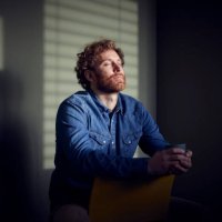 relaxed casual businessman sitting down with closed eyes - coffee stockfoto's en -beelden