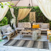 relaxing boho chic garden furniture under a gazebo creating a cozy outdoor space - garden decoration stock pictures, royalty-free photos & images