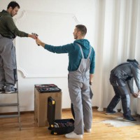 repairman team working together in client's house - home decoration stock pictures, royalty-free photos & images