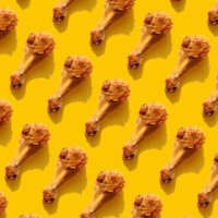 repeated fried chicken legs on the yellow background - junk food stock pictures, royalty-free photos & images