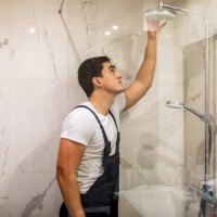 replacing the plumbing in the bathroom mounted hand shower holder with height adjustable a shower head. - home decoration stock pictures, royalty-free photos & images