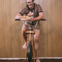 retro nineteen eighties aesthetic exercise bike man with donuts - junk food stock pictures, royalty-free photos & images
