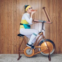 retro style exercise bike woman eighties era eating pizza - junk food stock pictures, royalty-free photos & images