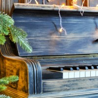 richly decorated for christmas with red and gold ornaments and lights on the background of an old piano. elegant card. closeup. copy spase - concert stock pictures, royalty-free photos & images