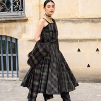 Rikako Yagi wears a Dior plaid dress and black boots outside the Dior show during Womenswear Spring/Summer 2025 as part of Paris Fashion Week on...
