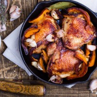 roast chicken legs with pumpkin in cast iron skillet - food stock pictures, royalty-free photos & images