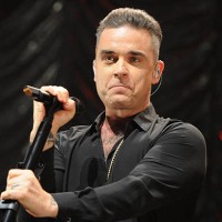 Robbie Williams performs on stage at Key 103 Christmas Live at Manchester Arena on December 9, 2016 in Manchester, England.