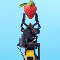 robotic claw holding strawberry - food fotografías e imágenes de stock