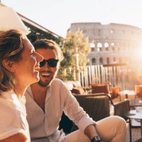 romantic couple having fun at sunset in rome, italy. colosseum and sunstar - travel stock pictures, royalty-free photos & images