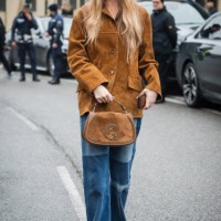 Romee Strijd is seen wearing a brown leather jacket, blue denim pants, sunglasses and brown suede Gucci Blondie bag outside Gucci during the Milan...