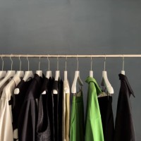 row of clothes on hangers - fashion stock-fotos und bilder