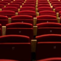 row of numbered theater seats in red velvet, with wooden armrests. theater, opera, show, artist, director and entertainment concept. - concert stock pictures, royalty-free photos & images
