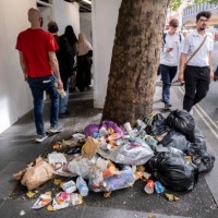 Rubbish bags and accumulated litter, drinks cups, bottles and fast food packaging on Charing Cross Road in central London on 23rd August 2022 in...