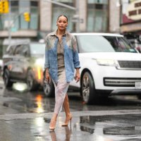 Sai De Silva wears silver earrings, dark plaid pattern collar shirt, light blue pattern/print oversized unbuttoned pattern/print long sleeve shirt,...