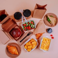 salad and fast foods with coffee cups against beige background - junk food stock pictures, royalty-free photos & images