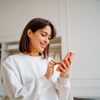 saleswoman making orders using phone, working in design department of clothes store - fashion stock pictures, royalty-free photos & images