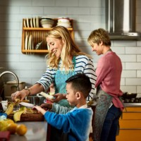 same sex couple cooking with son in kitchen - food stock pictures, royalty-free photos & images
