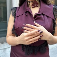 Samia Laaboudi wears a burgundy silk and lace top and skirt from L2R The Label, a burgundy orchid flower choker necklace from Kenza Klay, fantasy...
