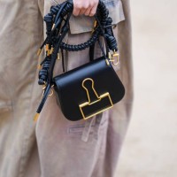 Sandara Park wears beige cargo / jeans, a black and gold leather bag, outside Off-White, during the Womenswear Fall/Winter 2024/2025 as part of Paris...