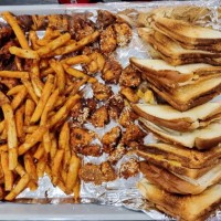 sandwiches, chicken and potato fries in a tray covered with silver foil. - junk food stock pictures, royalty-free photos & images