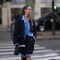 Sarah Lysander Svendby Carter is seen wearing a complete outfit from Miu Miu, consisting of a dark blue cardigan with collar featuring unfinished...