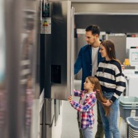 satisfied customers choosing fridge in domestic appliances section - home decoration stock pictures, royalty-free photos & images