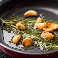 sauteed garlic and rosemary in olive oil - food stock pictures, royalty-free photos & images