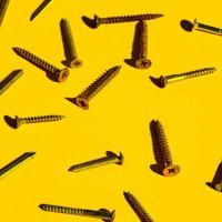 scattered screw nails on yellow color background. - nails art photos et images de collection