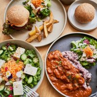 scene at a table with a couple enjoying lunch at a vegan cafe. - food stock pictures, royalty-free photos & images