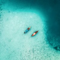 scenic aerial view of two boats on sea in thailand - travel stock pictures, royalty-free photos & images