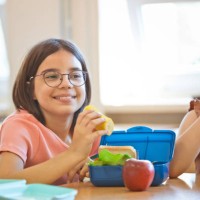 school girls having lunch - food stock pictures, royalty-free photos & images