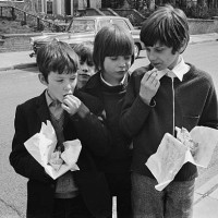 Schoolchildren eating chips because school meals are not being served due to a pay dispute, UK, 28th April 1971.