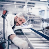 scientist writing on clipboard and working on production line - food stock pictures, royalty-free photos & images