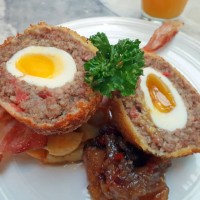 scotch eggs on bacon and caramelised onion - junk food stock pictures, royalty-free photos & images