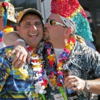 Scott Vincent, of Portsmouth NH gives a peck on the cheak to Kevin St. Pierre, of Natick, prior to the Jimmy Buffet Concert at Fenway Park, 9/12/04.