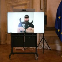 Screen displays a photo of a man arrested in connection with an Islamist attack plot that caused the cancellation of the Vienna leg of a tour by...